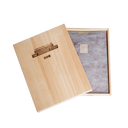 A wood box with the words "The Juventus Story" burnished into the wood on the cover. The cover is slightly to the side, revealing contents of the box: a brown leather pouch with five vertical stripes that are gold embossed in the center. The pouch is wrapped in translucent white tissue paper.